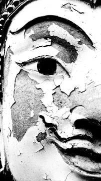 Close up half face of stone Buddha statue broken in monochrome tone Stock Photos