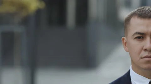 Close up of half face of upset Caucasian young businessman in looking straight Stock Footage 194518627