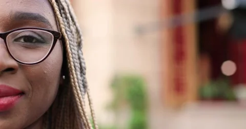 Close up of half face of young African American beautiful woman in eyeglasses Stock Footage 148244176