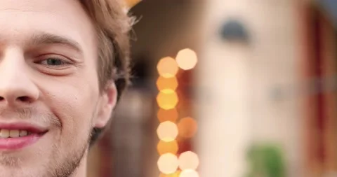 Close up of half face of young Caucasian handsome man with beard looking at Stock Footage 148244244