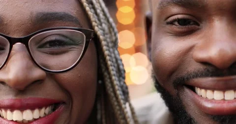 Close up of half faces of young African American handsome man and beautiful Stock Footage 148244162