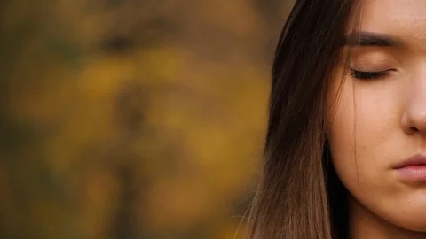 Close up of the half female face with long brown hair with close eyes and then o Stock Footage 120597916