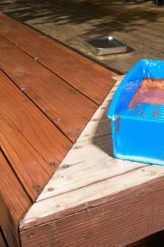 Close up of half finished decking oil paint job Foto stock