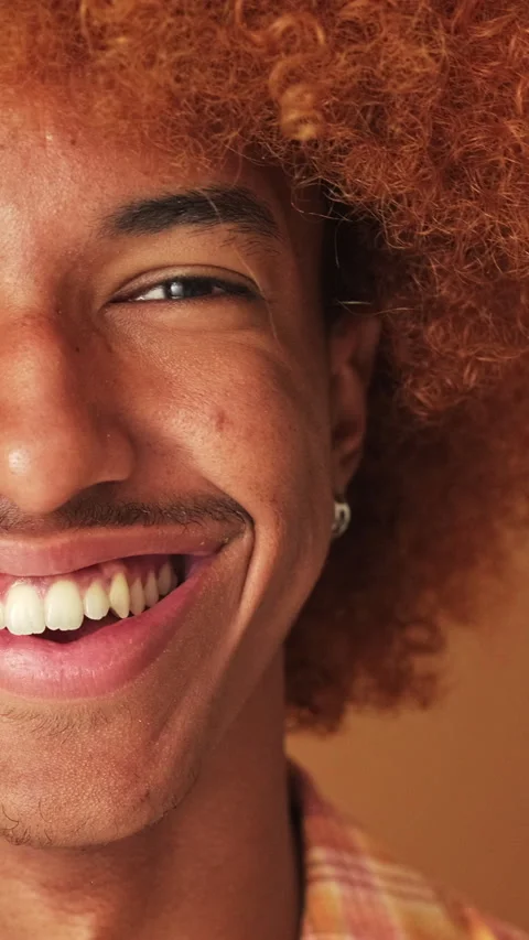 Close up,half of the guy's face smiling widely looking at the camera isolated on Stockbeeldmateriaal 253933653