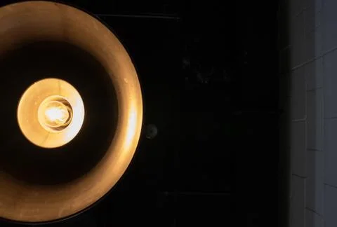 Close up half of hang yellow light lamp lantern on black background Stock Photos