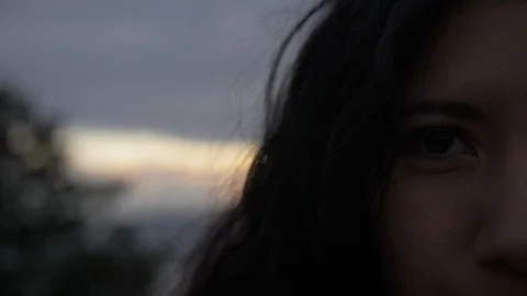 Close Up of Half of a Latina's Face During Dark Cloudy Sunset Stock Footage 90661909