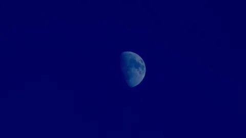 Close up of half moon with dark navy blue indigo clear sky background at night Stock Footage 246975229