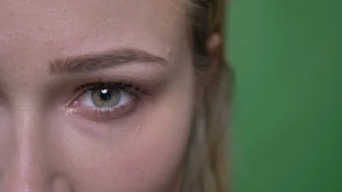 Close-up half-portrait of young blonde fashion model raises her eyes and watches Video stock 107639475