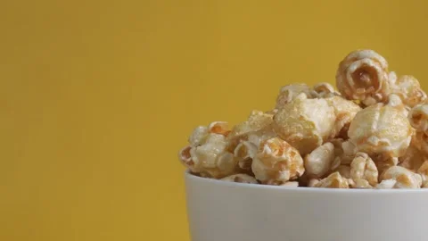 Close up half shot of a spinning white bowl of popcorn Stock Footage 279794235