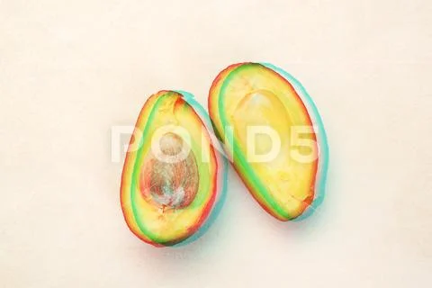 Close up of half sliced ripe avocado on white table with glitch effect Stock Photos