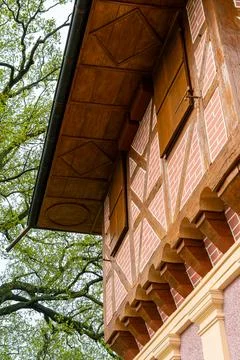 Close-up of half-timbered building facade with wooden roof Stock Photos