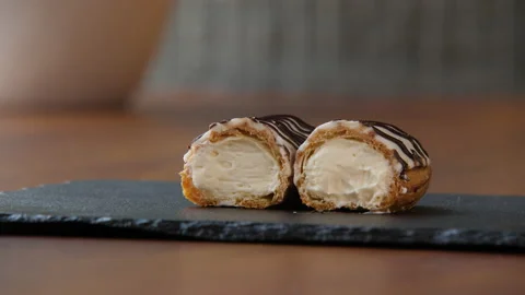 Close-up of a halved eclair with creamy filling 스톡 동영상 168187930