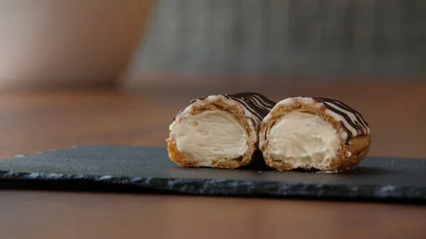 Close-up of a halved eclair with creamy filling 스톡 동영상 168188028