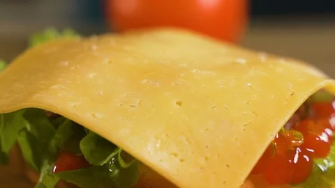 Close up: Hamburger roll falls on the cutlet, cheese and onionsю Slow motion 스톡 동영상 111343884