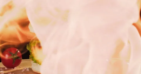 Close-up hamburger on a wooden board in fire. Fresh sesame seed bun with grilled Stock Footage 294512604