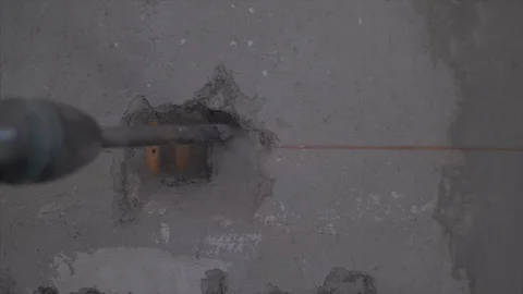 Close up of a hammer drill making a hole on the wall for the light switch Video stock 97774646