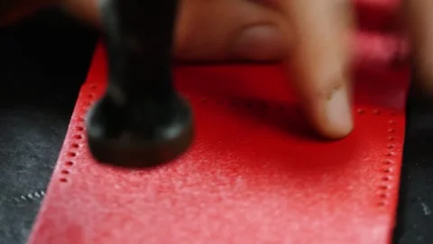 Close-up hammering leather edge to secure wallet parts Stock Footage 314961767