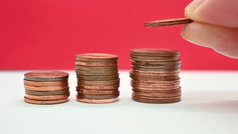 Close up of a hand adding a coin to a stack. Stock Footage 155894326