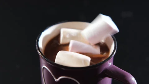 Close-up of hand adding marshmallows to hot cocoa Vídeo Stock 296215737
