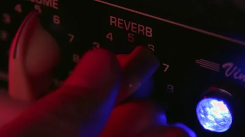 Close up of Hand adjust Reverb button of Guitar Amplifier Stock Footage 124086167