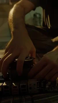 Close-up of a hand adjusting audio equipment in a dark room Stock Photos