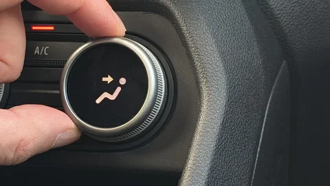 Close up of hand adjusting car climate control airflow direction knob Stockbeeldmateriaal 333307904
