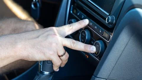 Close Up of Hand Adjusting Car Climate Control and Air Conditioning Stock Photos