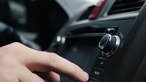 Close-up of hand adjusting car stereo knobs and pressing buttons for naviga.. Stock-Footage 334592870