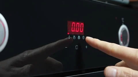Close-up of a hand adjusting the digital display of a microwave oven Stock Footage 307852892
