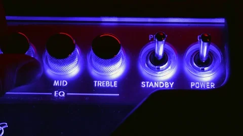 Close up of Hand Adjusting EQ on Guitar Amplifier Stock Footage 123859025