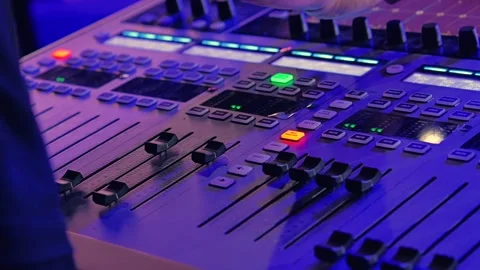 Close-up of a hand adjusting knobs and sliders on a music mixing console 스톡 동영상 305191071