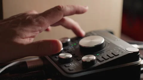 Close-Up of Hand Adjusting Knobs on Sound Mixer to Fine-Tune Audio Levels in 库存影片 283138408
