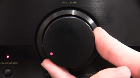 Close-up of hand adjusting music volume dial Stock Footage 89961368