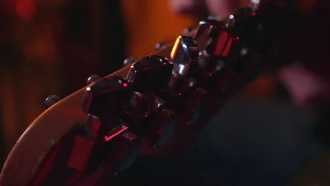 Close up of Hand Adjusting Peg of Electric Guitar Stock Footage 124086472
