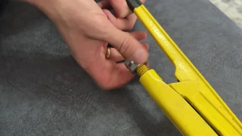 Close up of hand adjusting pipe wrench on fabric surface. Preparing plumbing Video stock 336978650
