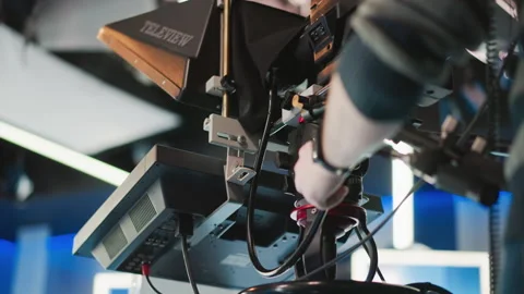 Close-up of hand adjusting professional camera rig with teleprompter in Stock Footage 317553342