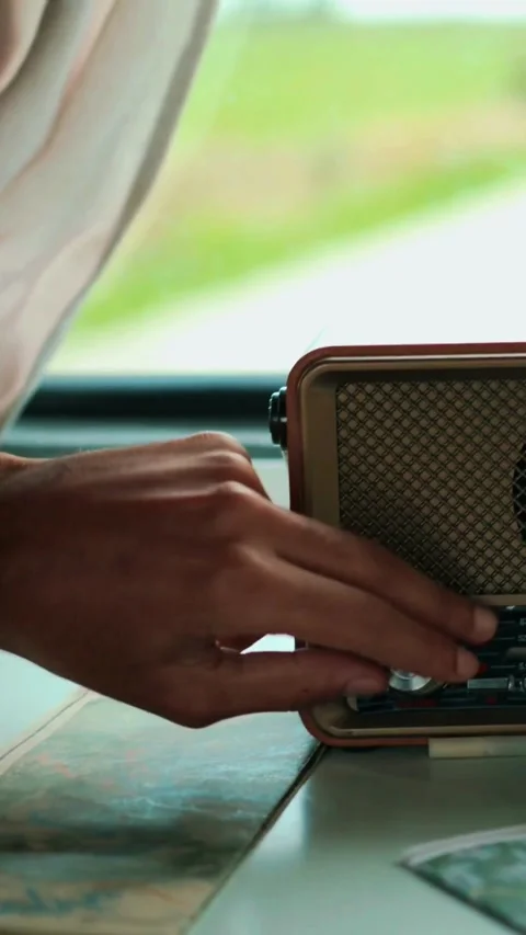 Close up of a hand adjusting a retro radio dial for audio broadcast. Video stock 342781005
