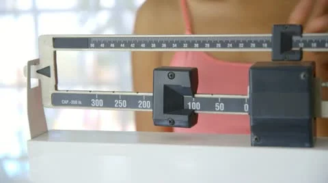 Close up of hand adjusting scale Stock Footage