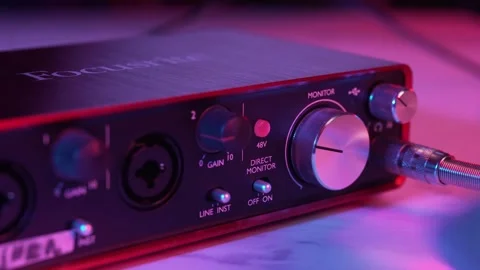 Close up of Hand Adjusting Volume Knob on Audio Interface Stockbeeldmateriaal 329787079