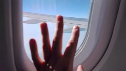 Close up of hand on airplane window in slow motion 120fps Video stock 152975700