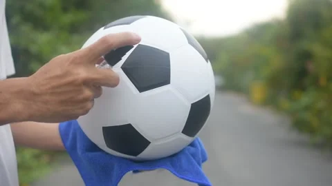 Close up hand Alcohol spray cleaning Football are New normal and Football League Stock Footage 130509363