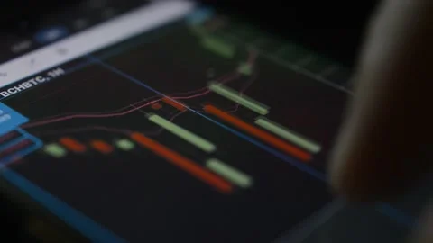 Close-up hand analyzing trading charts diagram on his iphone. phone trading Video stock 196281342
