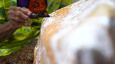 Close Up hand and canting, making Batik Tulis Indonesia Stock Footage 143974836