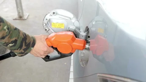 Close up of hand and fuel nozzle. Fuel nozzle getting put into its place Stock Footage 336569564