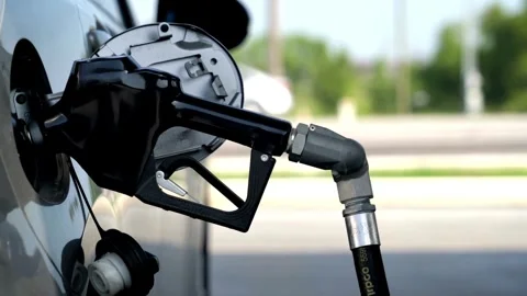 Close up of hand and fuel nozzle. Fuel nozzle getting put into its place Stock Footage 336569786