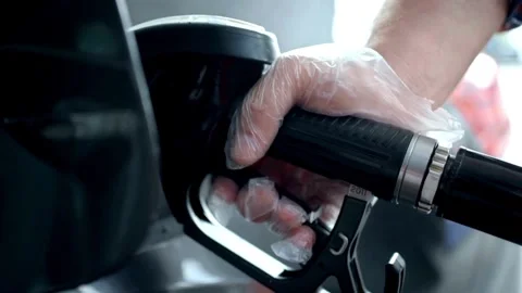 Close up of hand and fuel nozzle. Fuel nozzle getting put into its place Видео 336569790