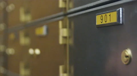 Close-up of hand and key opening a safety deposit box. Video stock 52319554