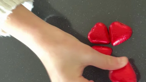 Close up Hand arranges red hearts in circle on dark background, love concept Stock Footage 327171384