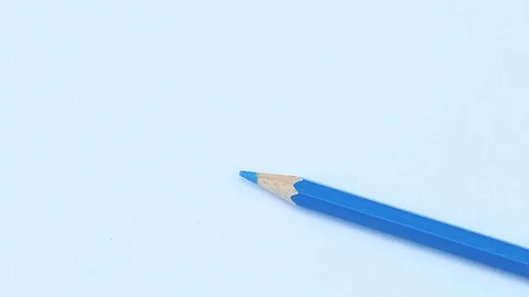 Close up hand of Artists,  Using blue color pencil write Blue on white paper  Stock Footage 105553925