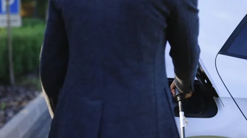 Close up of hand attaching power cable to environmentally friendly zero emission Stock Footage 249271912